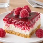 A delicious slice of Creamy Raspberry Cheesecake on a plate.