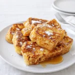 Golden Hawaiian Roll French Toast with syrup and berries