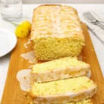 A sliced loaf of Vegan Dandelion Bread on a wooden board