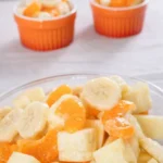A bowl of bright Sunshine Salad with pineapple and oranges
