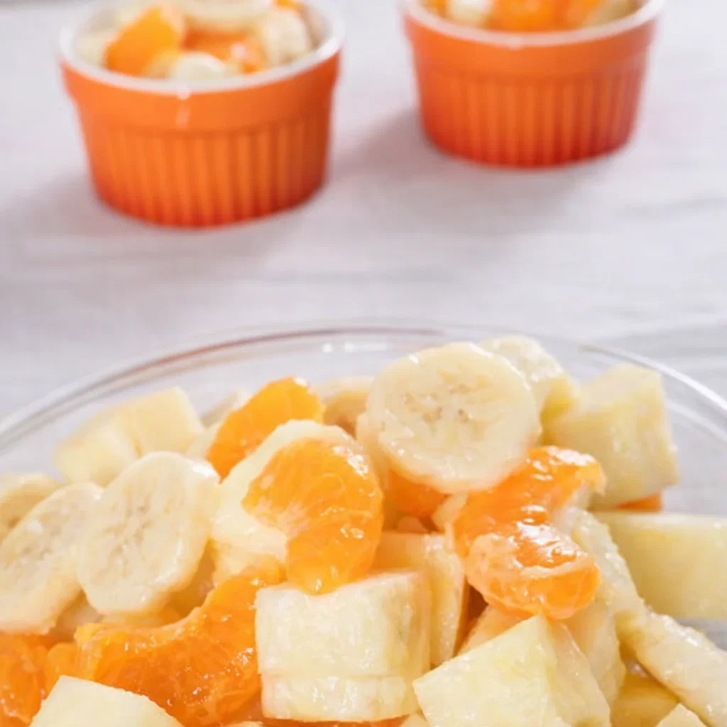 A bowl of bright Sunshine Salad with pineapple and oranges